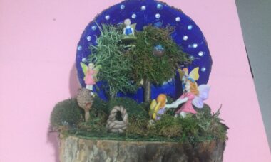 Fairy Garden scene on wood log slice