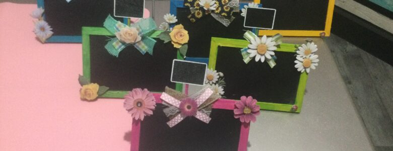 mini chalkboard easels painted in spring colors with flowers and ribbon added