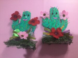 Cute cactus made of wood and facial scrub gloves