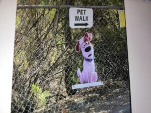 Pet Walk sign with painting of a cartoon dog